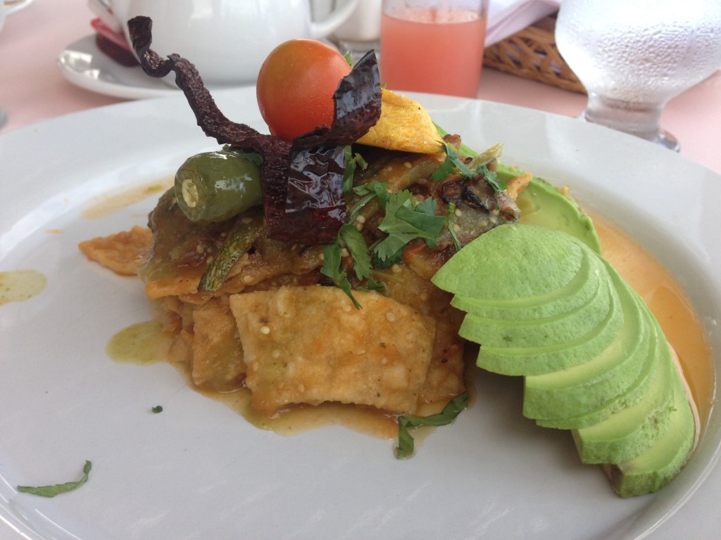 Breakfast at the hotel: Chilaquiles with a red mole and a side of sliced avocado