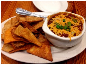 The vegan chili with pita chips is spicy and filling.
