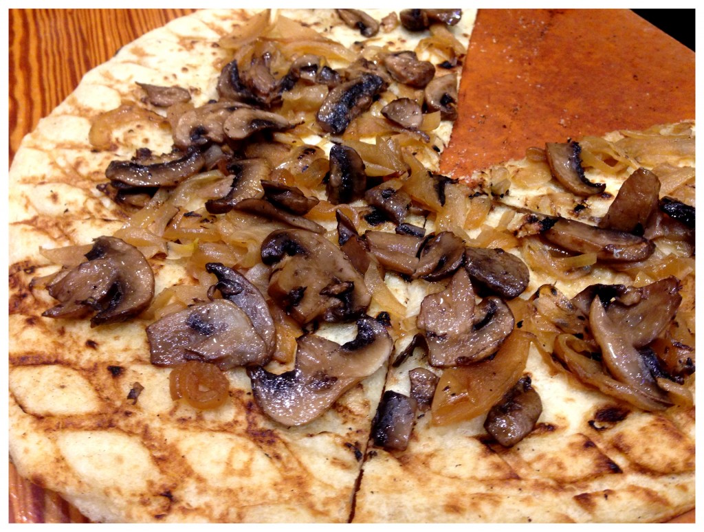 GrilledVegan Flatbread with mushrooms and roasted onions drizzled with extra virgin olive oil